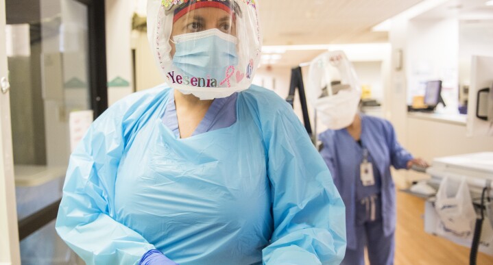 A nurse prepares her personal protective equipment before tending to a patient inside the Covid-19 unit of Salinas Valley Memorial Hospital in Salinas, Calif., on Sept. 2, 2021.