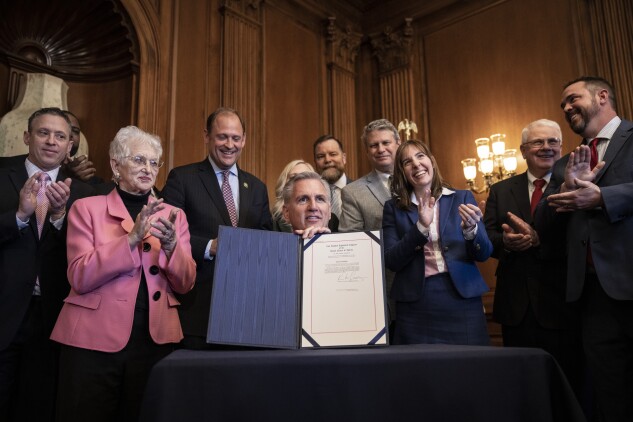 Former Speaker of the House Kevin McCarthy (R-Calif.) signs a resolution passed by the House and Senate that aims to block a Biden administration rule encouraging retirement managers to consider ESG factors when making investment decisions, during a bill signing at the US Capitol March 9, 2023.