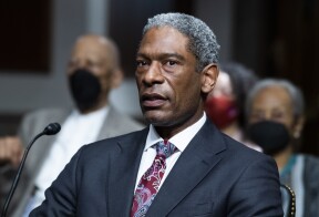 Judge Julien Xavier Neals, pictured during a Senate Judiciary Committee confirmation hearing in Washington in 2021, is staring directly at the camera. He is wearing a suit and patterned tie. 