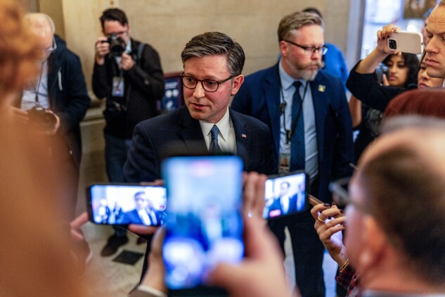Speaker Mike Johnson talks to reporters