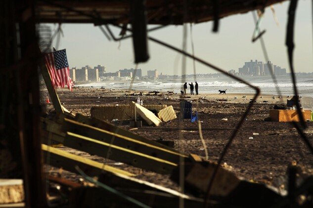 More than two weeks after Superstorm Sandy slammed into parts of New York and New Jersey, thousands were still without power and heat, and the beach in the Rockaway neighborhood of Queens, N.Y, was littered with debris where an iconic boardwalk had stood, Nov. 16, 2012.