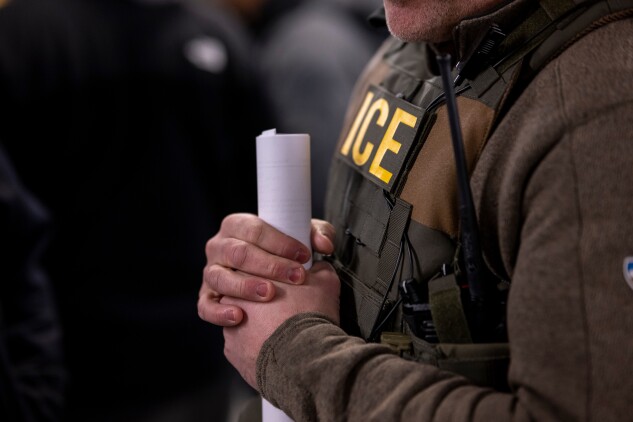 An Immigration and Customs Enforcement agent, along with other federal law enforcement personnel, attends a pre-enforcement meeting in Chicago on Jan. 26, six days after Trump took office. 