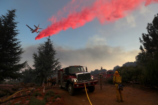 A firefighting aircraft dropped fire retardant ahead of the River Fire in Lakeport, Calif., as it burned through a canyon in August 2018.