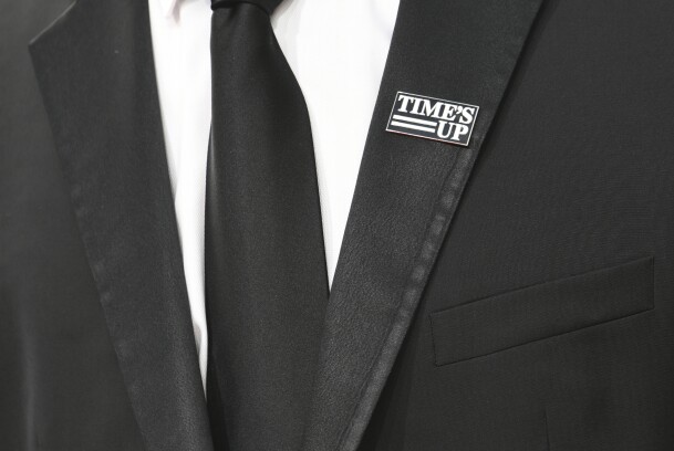 An attendee wears a 'Times Up' badge as he arrives for the 75th Golden Globe Awards on Jan. 7, 2018, in Beverly Hills, Calif.