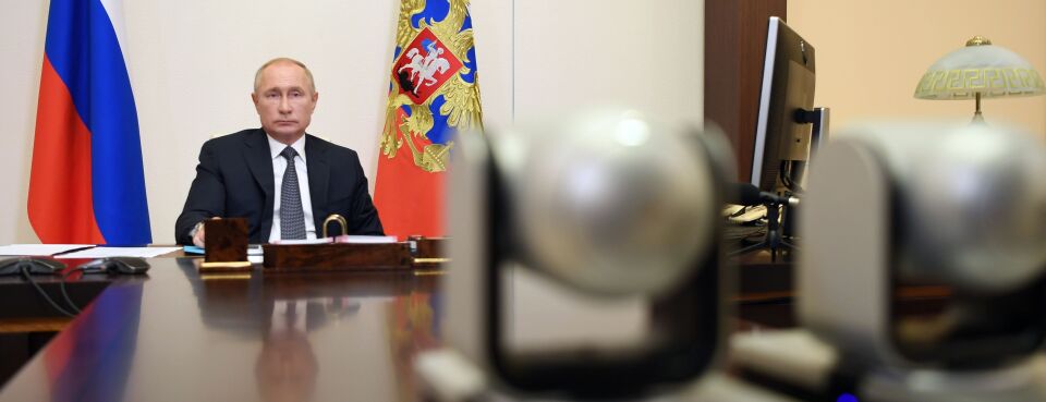 Putin - Insights: Russian President Vladimir Putin chairs a meeting with members of the government outside Moscow on Aug. 11, 2020.
