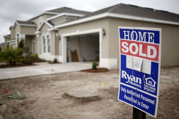 A 'Sold' sign is displayed outside a new house at a Ryan Homes Inc. development.