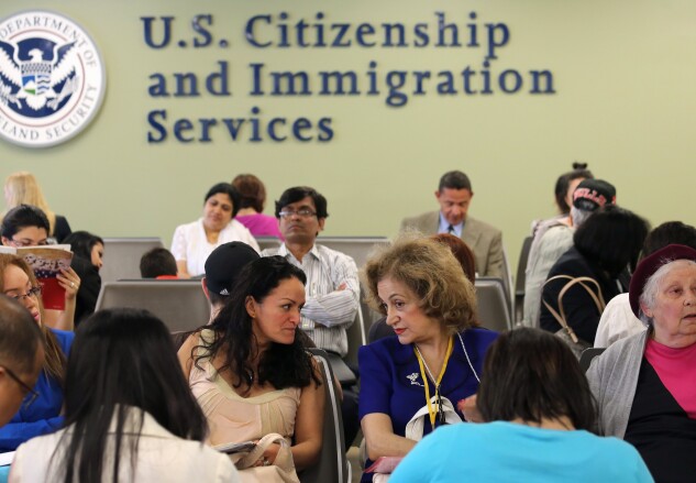 Immigrants await their turn for green card and citizenship interviews at the US Citizenship and Immigration Services (USCIS) Queens office.