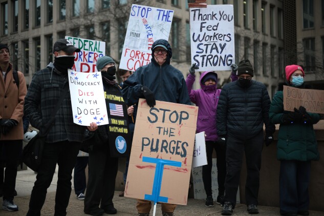 Protesters rally outside of the Theodore Roosevelt Federal Building headquarters of the US Office of Personnel Management on February 05, 2025 in Washington, DC.