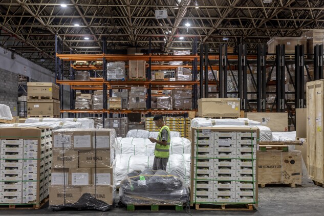 A worker near cargo in a storage facility at the exports terminal of Guarulhos International Airport in Sao Paulo.
