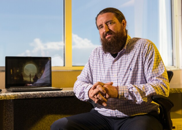 Jason Allen works inside his hotel room in Las Vegas in Sept. 2022.