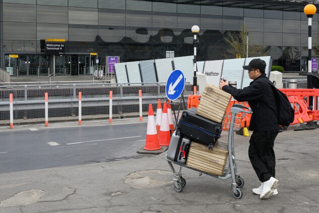 A passenger stands outside Terminal 4 of Heathrow airport on March 21, 2025 in London.